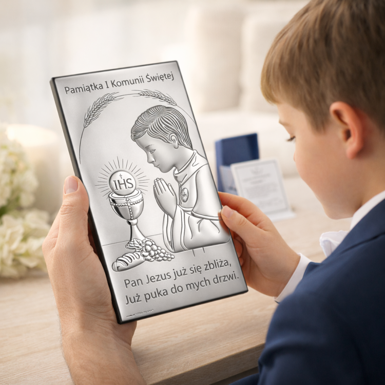 Rodzic i chłopiec oglądają srebrny obrazek komunijny – w tle oryginalne pudełko i certyfikat producenta