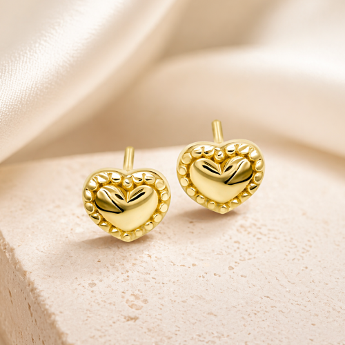 Złote kolczyki serca z wypukłym środkiem i ozdobnym rantem